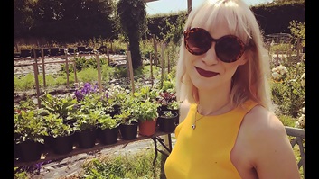 Maxine wearing sunglasses in a garden